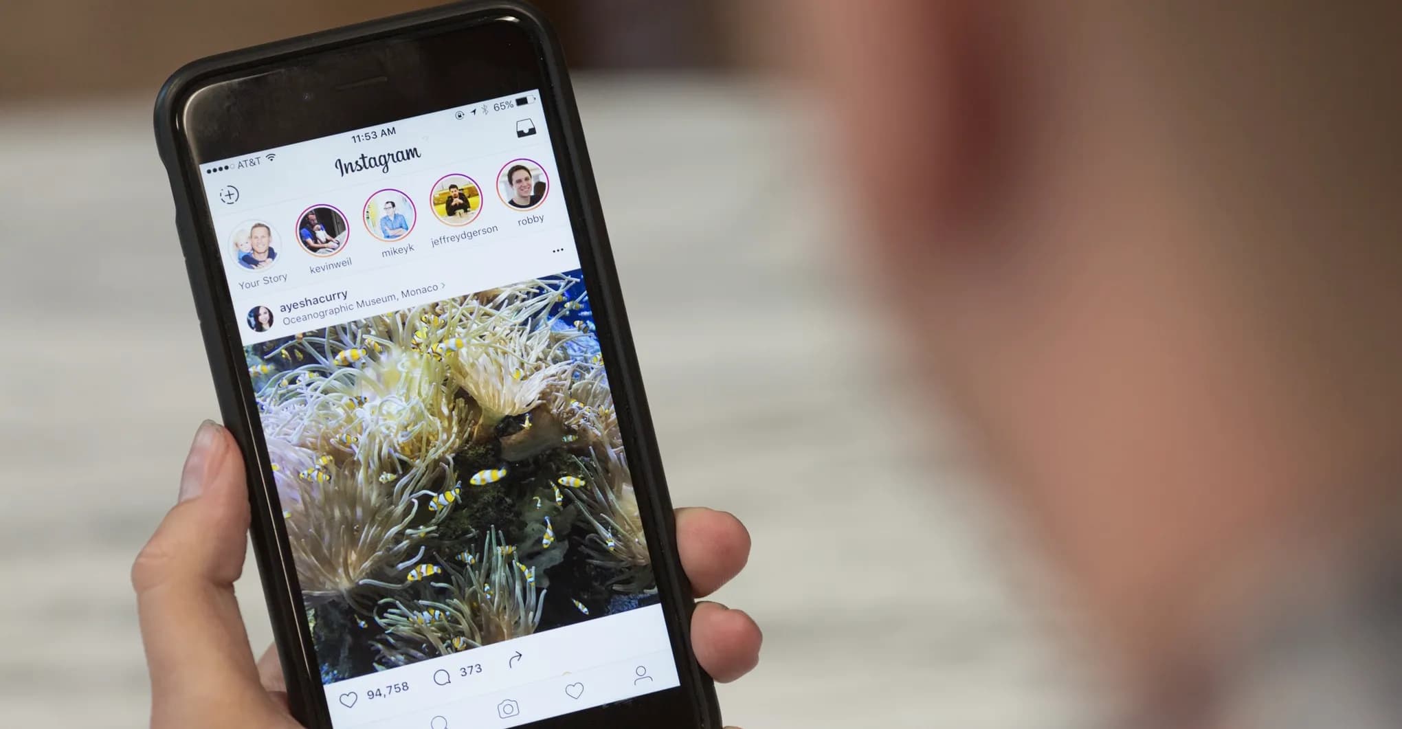 Person browsing a photo in the Instagram feed on a phone