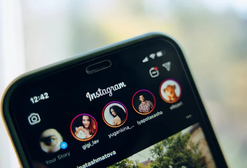 Close-up of Instagram stories, reels, and posts on a phone screen